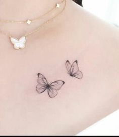 two butterflies on the back of a woman's shoulder