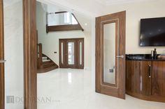 an open door leading to a bathroom with a television on the wall