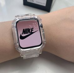 a person's wrist with a nike watch displaying the time on its display screen