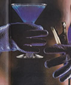 an image of a woman holding a martini glass in her hand with gloves on it