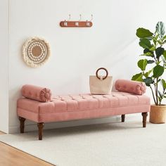 a pink bench sitting next to a potted plant