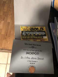 a ticket for jackpot is sitting on top of a piece of paper next to a penny