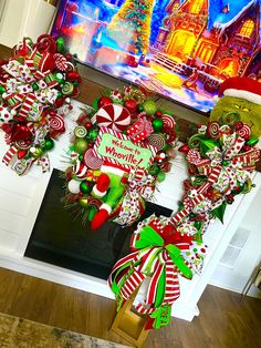 two christmas wreaths are hanging on the front door with candy canes and candies