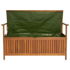 a wooden bench with a green cover over it