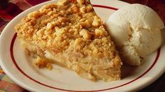 a piece of pie and ice cream on a plate with red trim around the edges