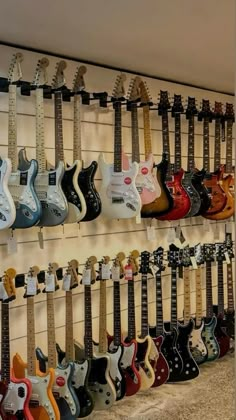 the guitars are lined up on the wall