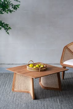 two chairs and a table with fruit on it