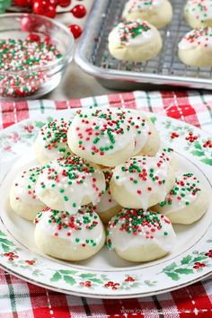 italian anise cookies with sprinkles on a white plate and red checkered tablecloth