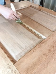 a person using a knife to cut wood