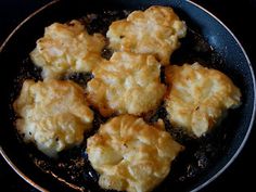 some food is cooking in a pan on the stove top and ready to be eaten