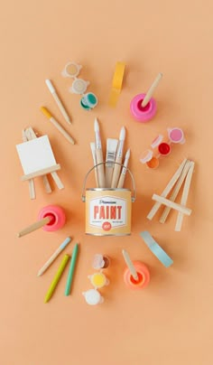 an assortment of craft supplies arranged in a circle on a pink background with the words paint written across it