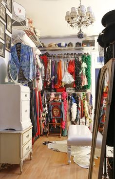 a closet filled with lots of different types of clothes