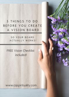 a woman's hand is holding a book with the title 5 things to do before you create a vision board