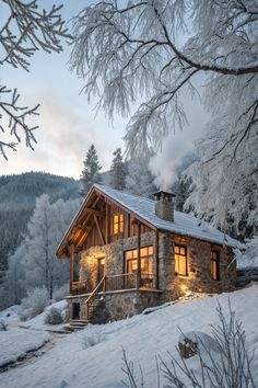 a cabin in the middle of winter with snow on the ground and trees around it