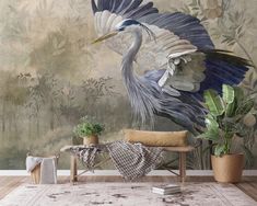 a painting of a blue heron on a wall in a living room with potted plants