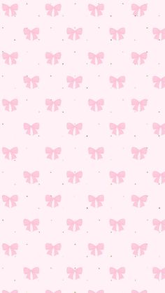 a pink wallpaper with small bows on it