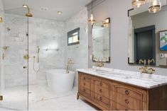 a bathroom with two sinks and a bathtub next to a walk in shower area