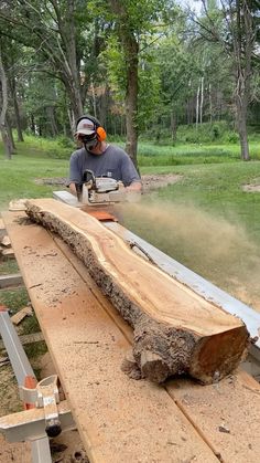 a man using a chainsaw to cut wood