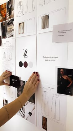 a woman is working on her project with paper and magnets attached to the wall