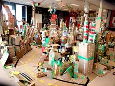 a room filled with lots of cardboard boxes and paper mache sculptures on top of each other