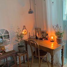 a table with some plants and candles on it