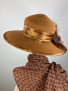 This butterscotch/camel/caramel widebrim hat is flat out fabulous! It is hand blocked over a vintage hat block and hand sewn with many tiny stitches. The crown (top) of the hat comes to a soft point and the brim has a slight down turn. Millinery wire is sewn inside of the brim edge to help the hat keep it's shape. The band and brim edge is a gorgeous hand dyed silk ribbon. It's finished with a three loop now, two pretty beaded sequin flowers, coordinating feathers and a large bow of vintage nett Winter Gatsby Fitted Hat, Elegant Beige Winter Fedora, Elegant Party Hats For Fall, Elegant Fall Party Hat, Luxury Brimmed Fedora For Fall, Adjustable Elegant Brown Felt Hat, Brimmed Cloche Hat For Party In Fall, Brimmed Cloche Hat For Fall Parties, Winter Evening Fedora Felt Hat