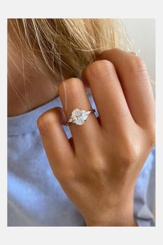 a woman's hand with a diamond ring on it