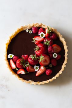 a chocolate tart with strawberries on top