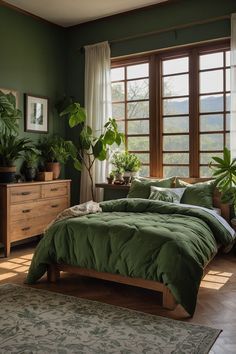 a bedroom with green bedding and plants on the window sill in front of it