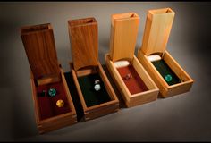 three wooden boxes with different types of rings in them