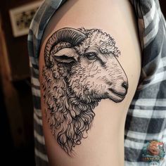 a black and white sheep tattoo on the arm