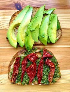 an avocado sandwich is cut in half and topped with red peppers, green pesto