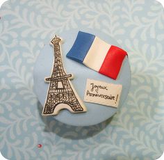 a cupcake decorated with the eiffel tower and flag