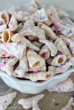 a white bowl filled with cereal and sprinkles