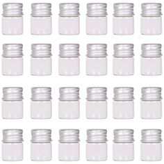 many small glass jars are lined up against the white background, with one empty jar in the middle