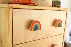 a wooden dresser with rainbow magnets on it