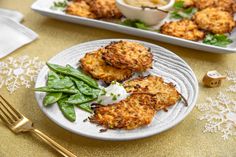 crab cakes are served on a plate with greens