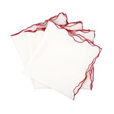 four white napkins with red thread on them