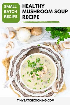 a white bowl filled with mushroom soup on top of a table next to mushrooms and parsley