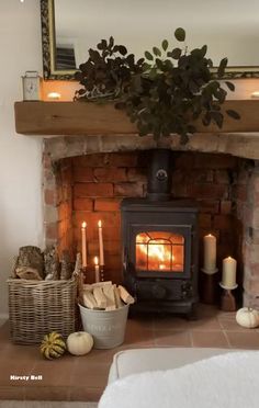 a living room with a fire place and candles