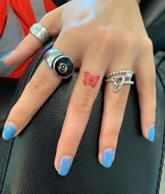 a woman's hand with a butterfly tattoo on her left ring and the word instagram above it