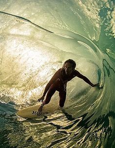 a man riding a wave on top of a surfboard