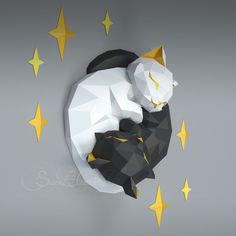 a black and white cat laying on top of a wall next to yellow star decorations