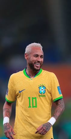 the soccer player smiles as he walks on the field