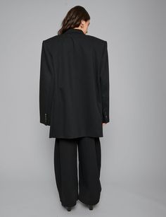 Oversized black blazer with padded dropped shoulders. Styled with matching barrel pants. 62% polyester, 35% viscose, 3% spandexFully linedFit is oversized Double Button closure Button sleeve cuffFront slit pocketsFaux chest pocketTotal length 32"/ 81 cmChest 42"/ 107 cm Extra padded shoulders Model is wearing one size and model's height is 5.8"/172cm Imported Oversized Black Blazer, 1st Photoshoot, Womens Oversized Blazer, Barrel Pants, Spring 2025, Long Blazer, Womens Blazers, Oversized Blazer, Black Blazer