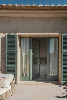 an open patio door with shutters on the outside