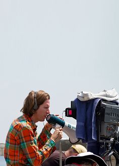 a man with headphones on is using a megaphone