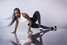 a woman in black and white is posing for the camera with her legs spread out