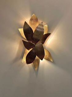 a decorative wall light that has been designed to look like a flower