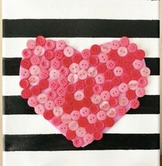 a heart made out of buttons on a white and black striped paper bag with the word love written in it